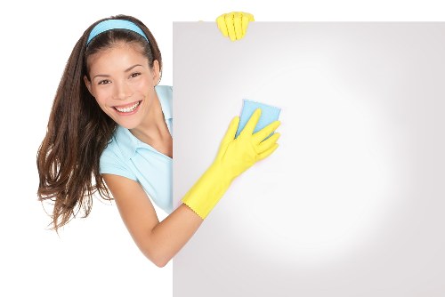 Professional carpet cleaner preparing equipment with safety awareness